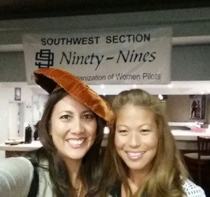 Two women in front of SWS 99s sign